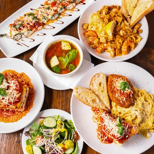 An overhead view of a table filled with various vegan Italian dishes from Tarantino's Vegan.