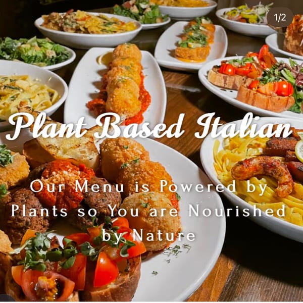 A table filled with various vegan Italian dishes, including pasta, bruschetta, and fried appetizers.